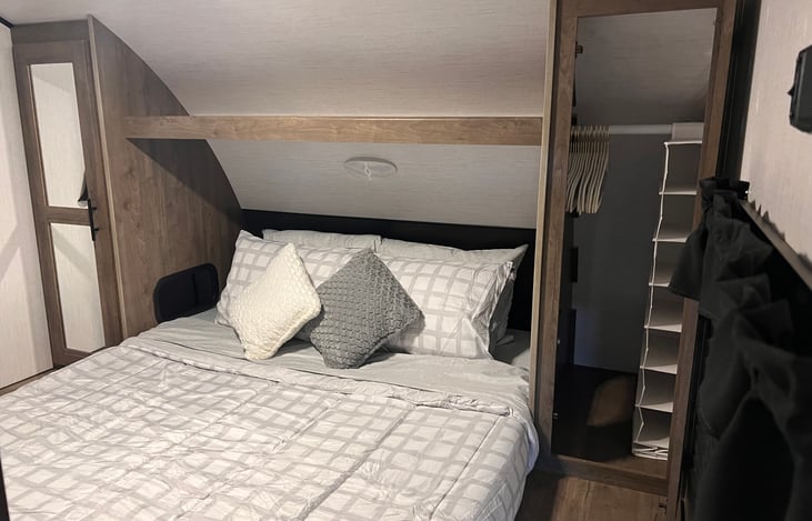 Main bedroom is spacious. There are two closets stocked with hangers and storage cubicles.