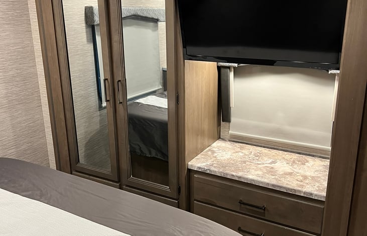 TV in the main bedroom and normal depth closet to hang clothes