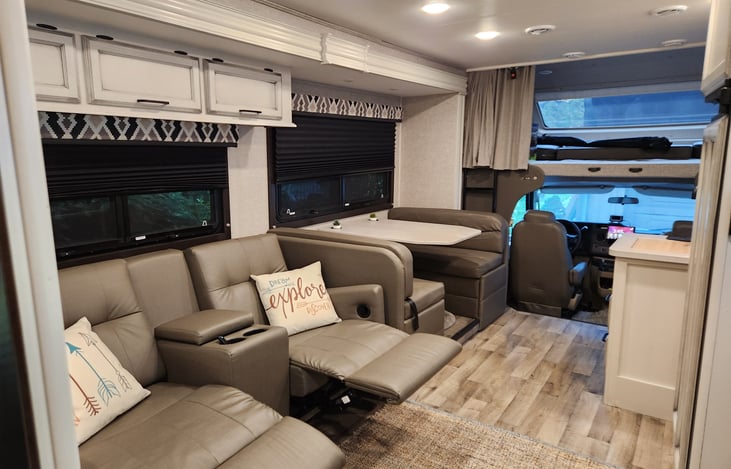 Theater-seating and dining table across from fireplace + HDTV (side pullout)