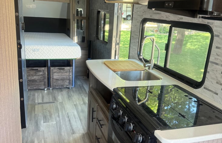 Windows on every side except for the bed (camper front).