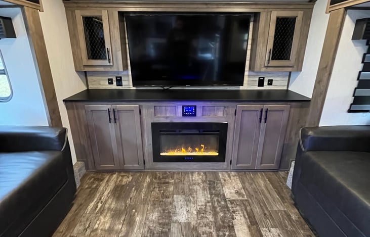 big screen TV, radio, and fireplace