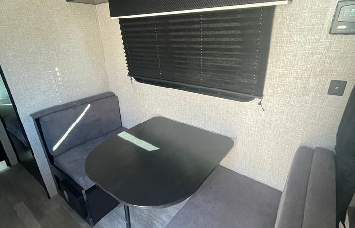 Dining area with table transformed into twin bed. Excellent condition