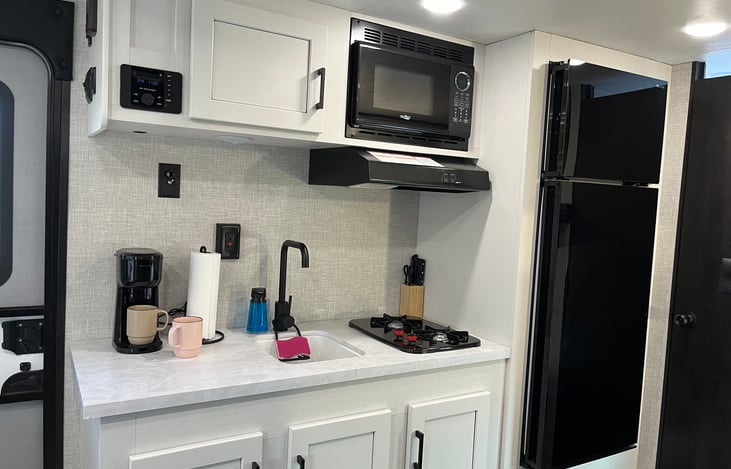 Coffee maker and included coffee K-cups along with a full kitchen set.