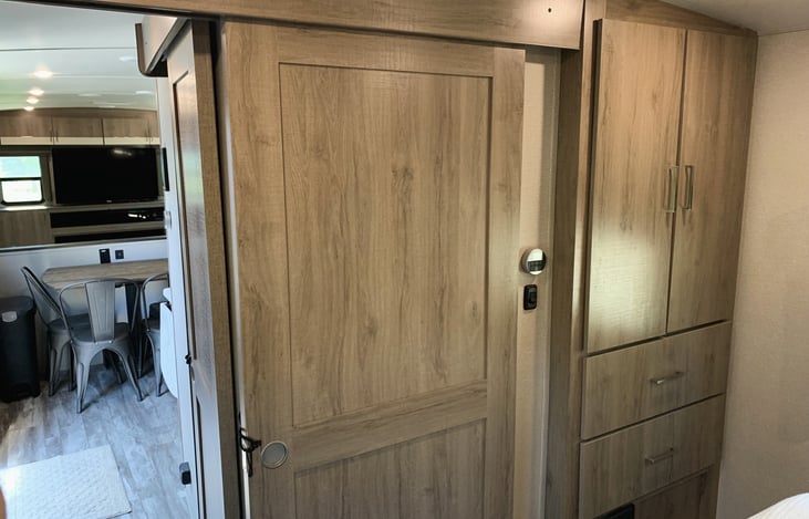 Bedroom storage space with sliding privacy door