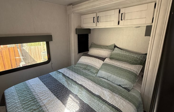 Comfortable master bed with private door.