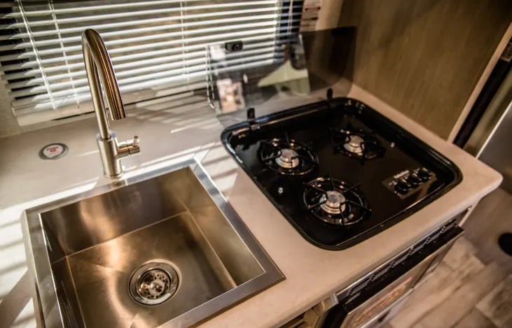 3 burner gas stove and a deep stainless steel sink!