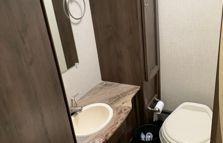 Large bathroom for an RV, real door closes for privacy, lots of bathroom storage.