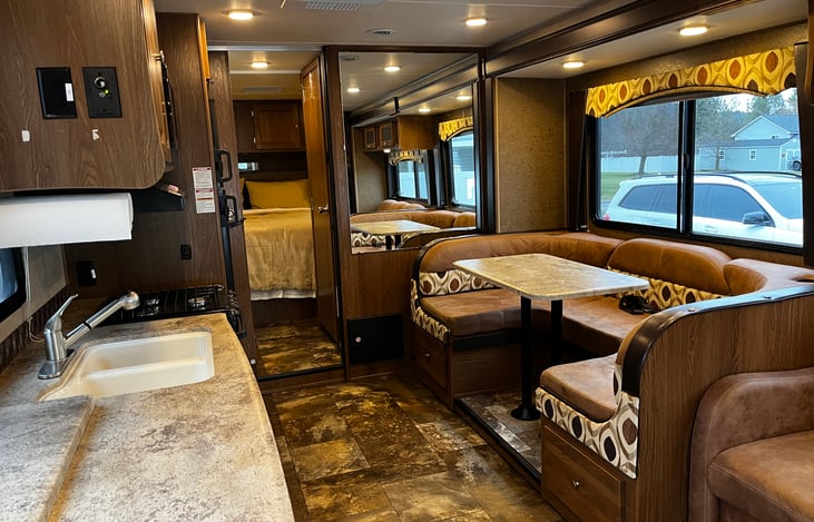 Main living area with 1 auto slide out. Full dining table makes into a comfortable bed also.