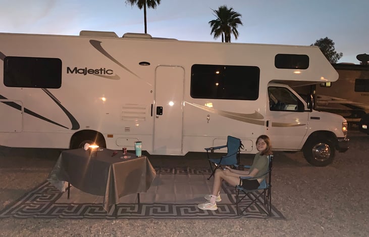Two folding chairs, outdoor carpet and table