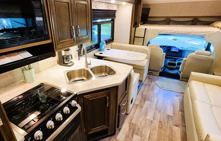 When the slide out is in while driving, there is still plenty of walkway to move about the cabin.    You can still access the bathroom, bunk beds and master bedroom.