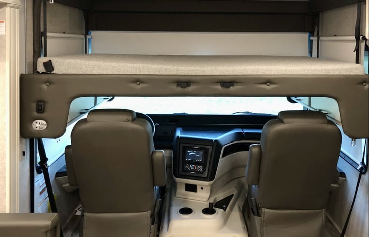 King-size bed over driver area with one-touch electric raising and lowering.