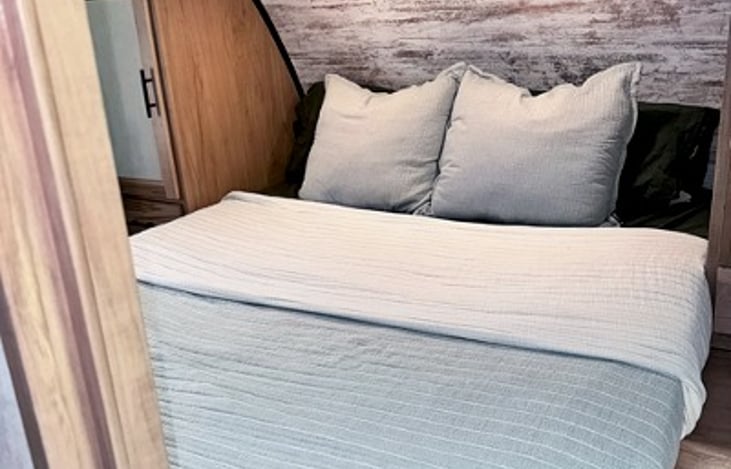 Private queen bedroom with storage and comfortable sleeping accommodations.
