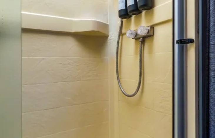 Stay refreshed on the road with a private shower — part of a Burning Man ready, glamping RV rental that keeps you comfortable wherever you go