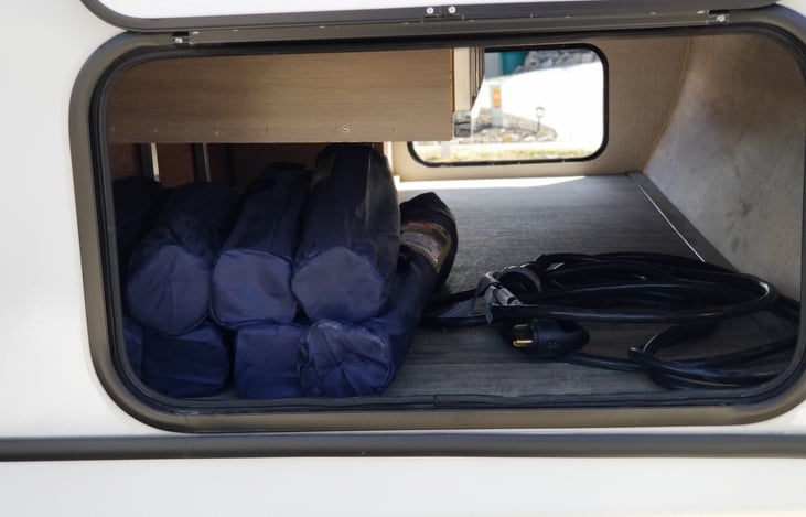 Large stowage compartment.  Includes camp chairs and power cord