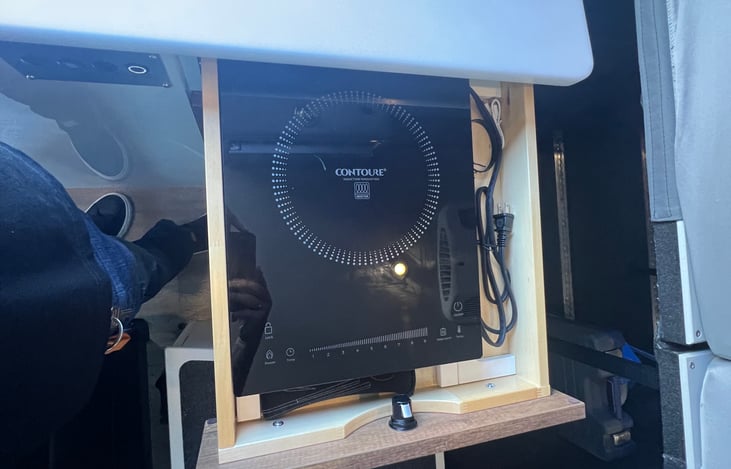 Induction top mobile stove that can be moved from the drawer to the countertop to outside.