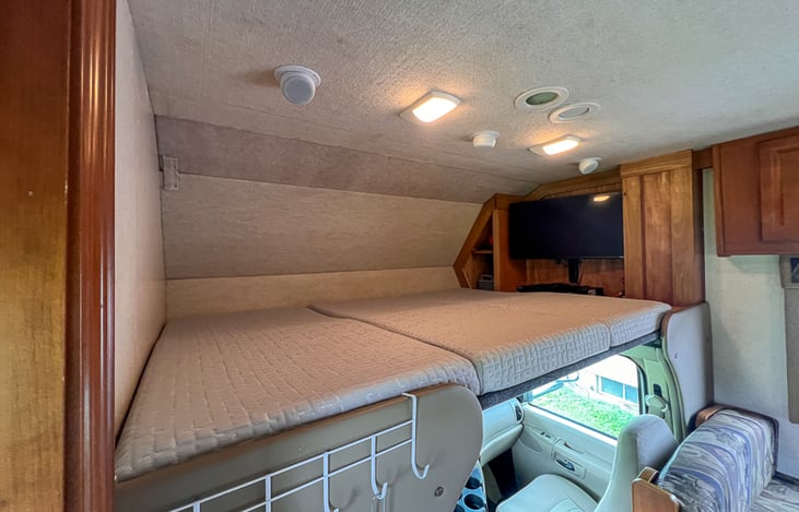 Entertainment unit and sleeping quarters.  Full XL (54"x 80") space for two medium sized adults.  No more need to convert the sofa or dinette.  Easy peasy!