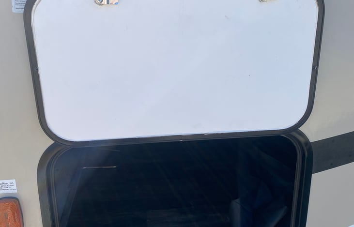 LARGE PASS THRU DOOR WITH MAGNET.  YOU WON'T NEED TO HOLD THE DOOR UP WHILE INSERTING OR REMOVING YOUR GEAR.