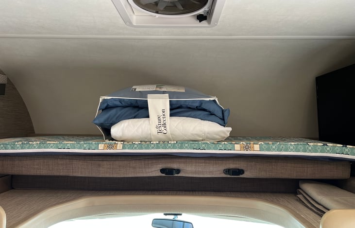 Bed above cab plus pad and lines included! Additional fan above bed area with lighting