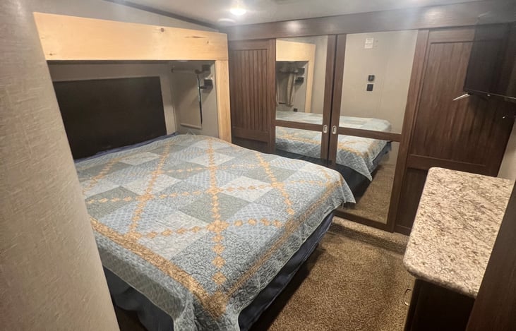 Primary bedroom with queen size bed & tv.