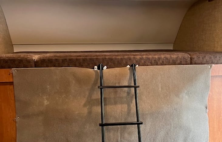 An easy to climb strong ladder with a privacy screen between the cab and main cabin.