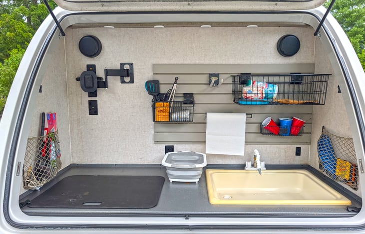Outside kitchen off rear of trailer with lift door that will keep you dry