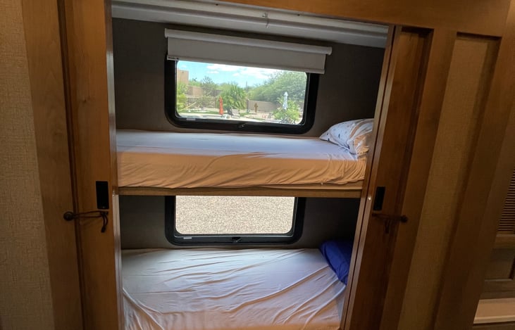 Cozy bunk beds each with DVD enabled TVs inside