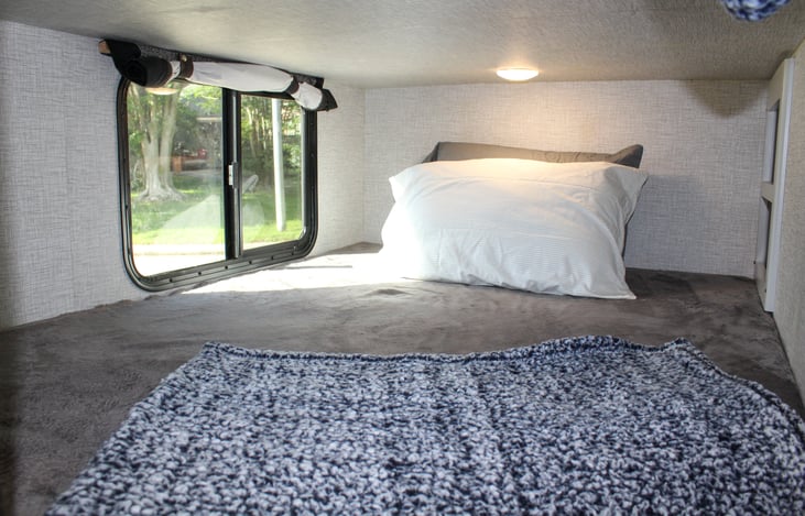 Bottom bunk- comes with its own view, overhead light, small shelf with 2 usb charging ports!