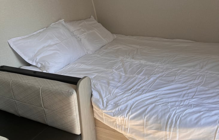 Bed has mattress protector, pillows, and bedding. Since this picture was taken we actually added a full size super thick queen mattress (as opposed to regular RV mattress) and it’s sooo comfy.