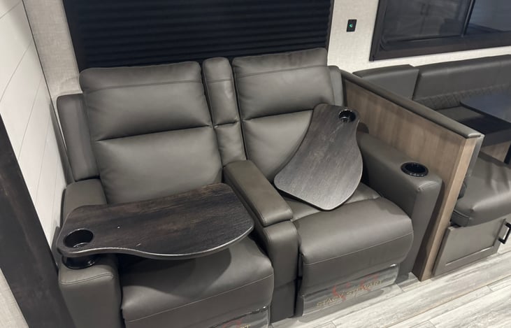 Main sitting area - Theatre style seating. Reclines, removable table trays and can sleep 2. Very conformable chairs!