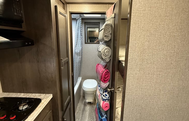 Deep full length storage closet with shelves. Bathroom comes equiped with a mirror and towels