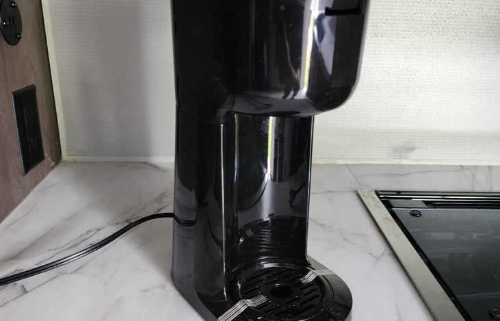 Coffee maker takes K cups or grounds. Makes single cup at a time.