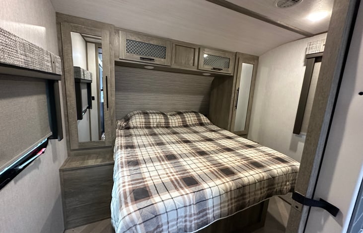 QUEEN SIZE BED INSIDE THE MASTER  BEDROOM. PLENTY OF STORAGE UNDER THE BED AND HANGING SPACE IN THE CLOSETS. USB PORTS NEXT TO BED FOR EASY CHARGING OF PHONES. AND LOTS OF LIGHTING.