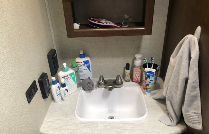 Ever had someone in the bathroom but needed the sink/vanity? With this sink/vanity you can do it all. Propane/electrical switch fresh and grey/black  tank volume and GFI plug also located here.