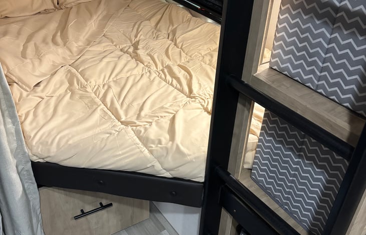 lower full bunk with window, outlet and storage