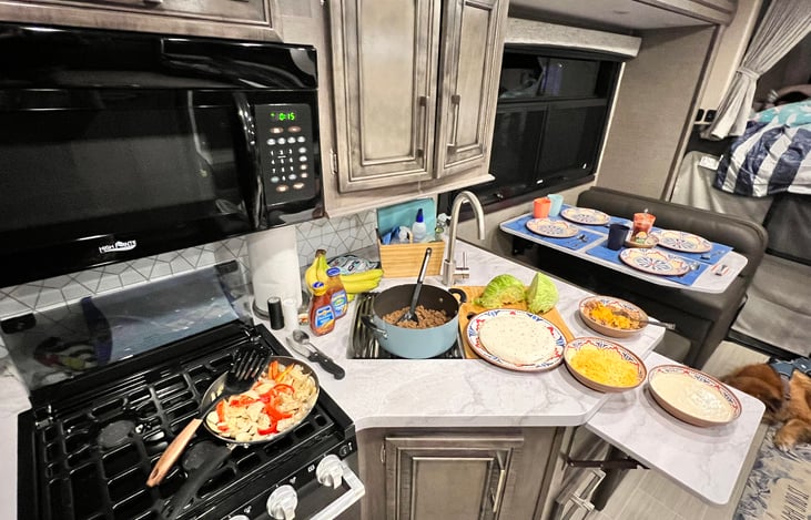 Full size microwave, 3 burner stove, oven, double sink and lots of counterspace!  Perfect combination for taco night, our families favorite RV meal!