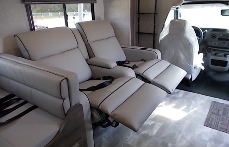 Two comfy seat belted recliners directly behind the driving area