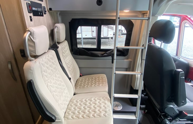 Rear seating (with two 3-point seat belts).  Collapsible ladder provides access to the pop top.