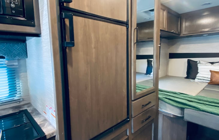 Large fridge. Wardrobe with mirror.