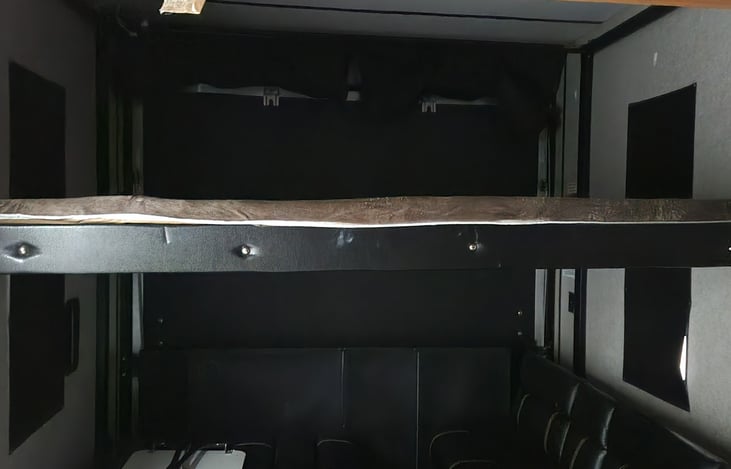 bed in toy hauler.   The dining table booth can be converted to a bed also making these bunk beds.