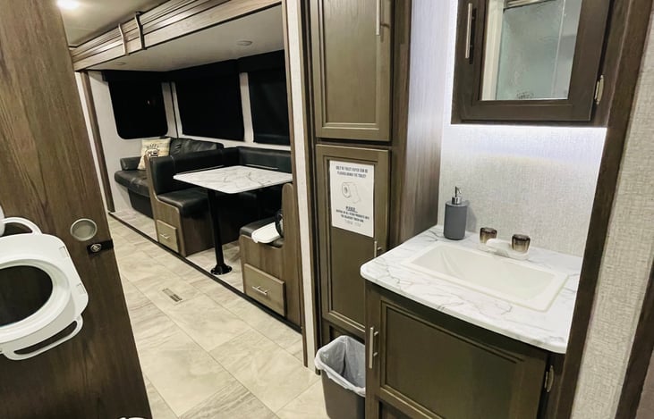 Full bathroom with plenty of storage. Towels and washcloths provided, as well as potty seat for any littles that might need some extra comfort.