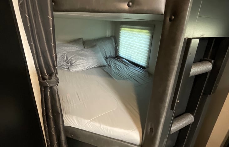 Bottom Bunk with 2” Gel-infused memory foam mattress topper. Window opens for emergency exit or for outside air circulation.