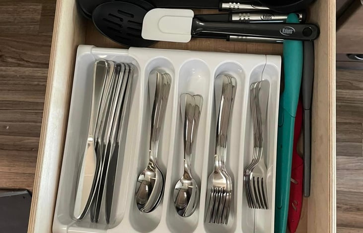 Full assortment of eating and kitchen utensils.