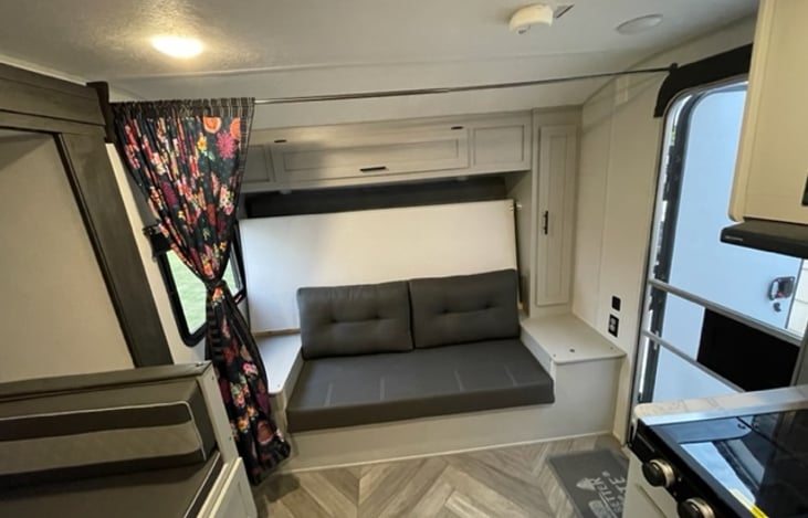 Couch for sitting! Notice the master bed behind. A murphy bed was a MUST for my wife and I to ensure the kids were not sitting or playing on our bed. Please note the storage above and side of the bed.