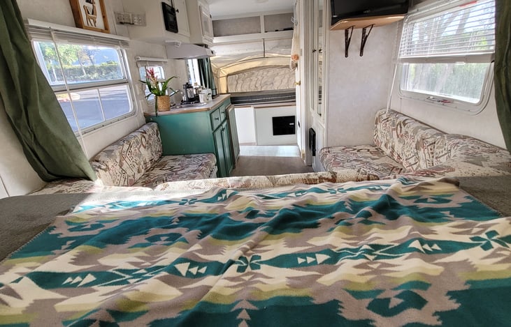 view from inside queen bunk full view camper to other bunk.