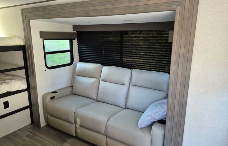 Modern luxury inside! Features a private master queen, double bunks, a huge U-shaped dinette slide-out, a fully loaded kitchen, a 10.2 cu ft fridge, a full bath, and premium JBL sound.