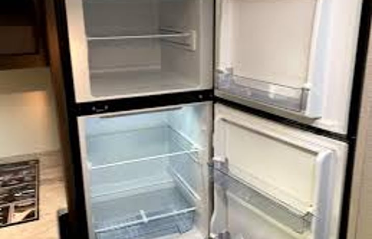 12V fridge is full 8 cu ft and runs off battery and solar panel on roof.