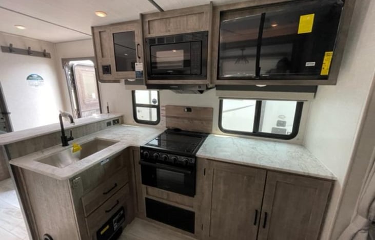 Kitchen with Ample Counter Space and Storage. TV, Microwave, and Oven.

Vacuum under sink near floor