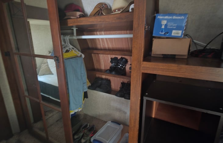 A very spacious closet with built in separate shoes storage