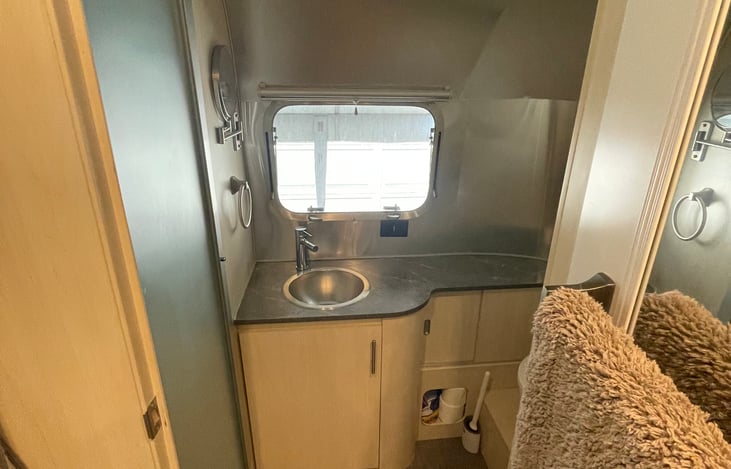 Bathroom comes with the basics. Toilet bowl brush and cleaner, T.P. , Hand soap, Hand towel, small mirror attached to wall.