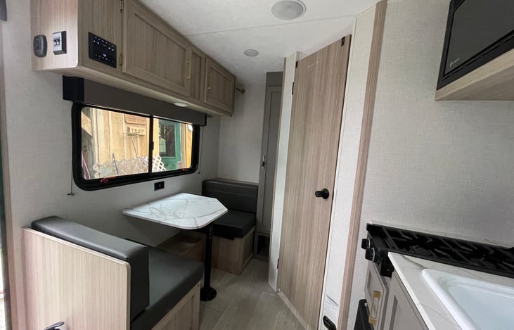 The dinette for two, storage above and beneath both seats. In addition there is a one foot space for hanging clothing in the corner behind the rear seat.